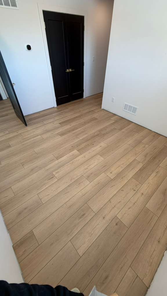 Light wood-look flooring installed in a bedroom