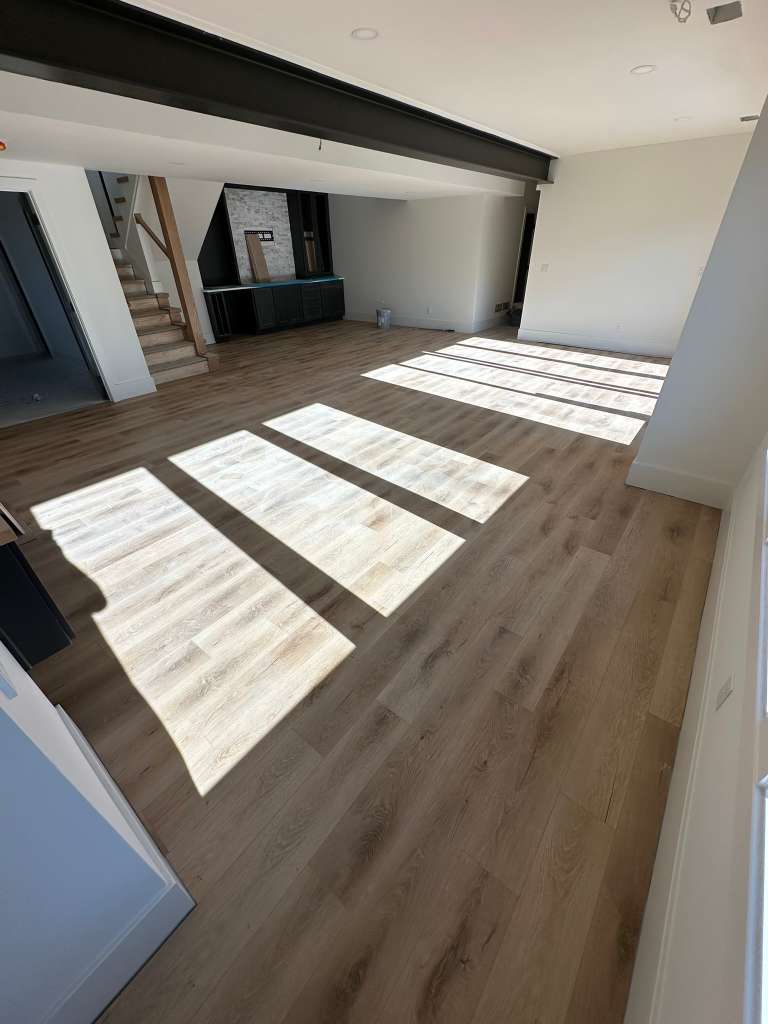 Luxury vinyl plank flooring installed in an open living room